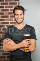 Handsome man holding a pint of beer