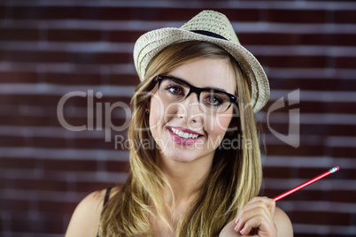 Smiling woman with a pencil