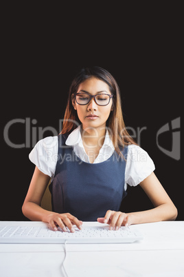 Serious businesswoman using a computer