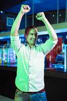 Happy man dancing in front of bar counter