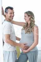 Man holding pregnant womans stomach