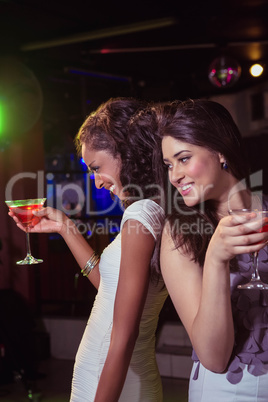 Happy young women having red cocktail