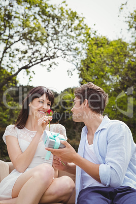 Man giving a surprise gift to woman