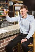 Handsome man holding a glass of whiskey