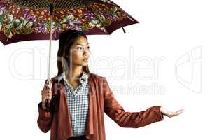 Businesswoman with an umbrella feeling the rain
