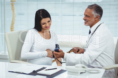 Doctor measuring pressure of pregnant woman