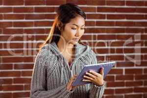 Focused asian woman using tablet