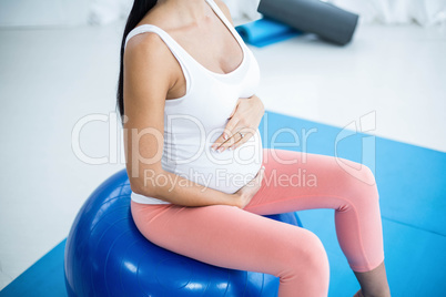 Pregnant woman exercising on exercise ball