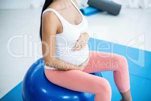 Pregnant woman exercising on exercise ball