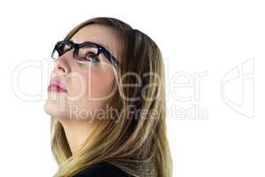 Thinking woman with glasses looking up