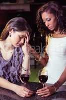 Woman having drinks and comforting her depressed friend