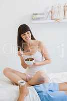 Young couple having breakfast on bed