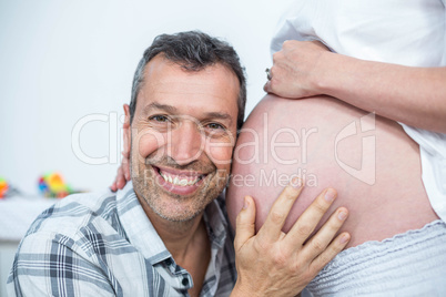 Man listening the belly of pregnant woman