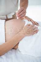 Pregnant woman in an acupuncture therapy