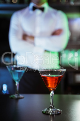 Two glasses of cocktail on bar counter