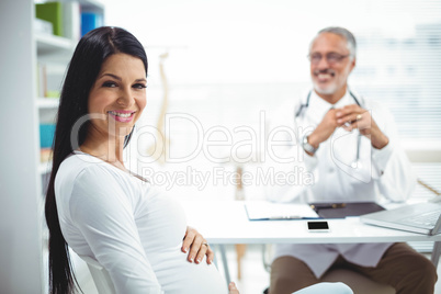 Pregnant woman sitting at clinic for health checkup