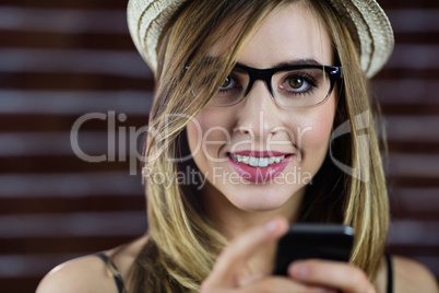 Smiling woman using smartphone