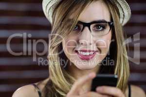 Smiling woman using smartphone