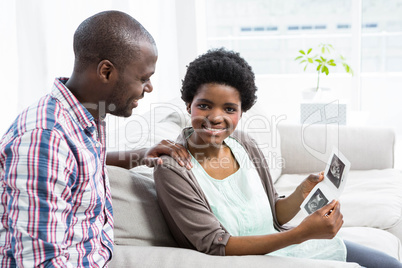 Pregnant couple looking at ultrasound scan