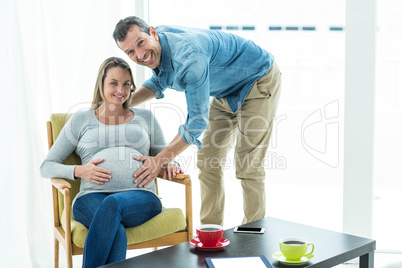 Man holding pregnant womans stomach