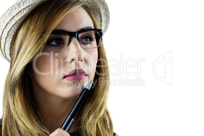 Woman touching her chin with a pen