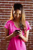 Concentrated asian woman using smartphone
