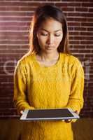 Focused asian woman using tablet