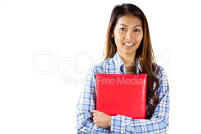 Smiling asian woman holding red book