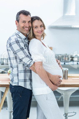 Pregnant couple in kitchen