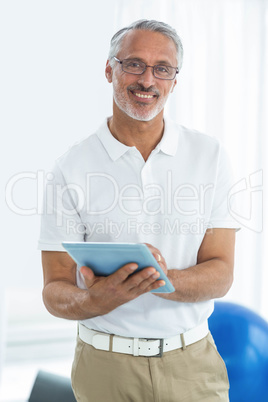 Physiotherapist using digital tablet