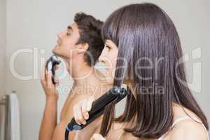 Couple shaving brushing hair