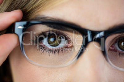 Close-up of woman touching her glasses