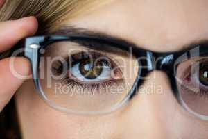 Close-up of woman touching her glasses