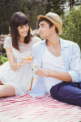 Young couple having glass of wine in garden