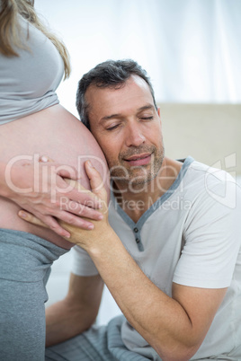 Man listening to pregnant womans stomach