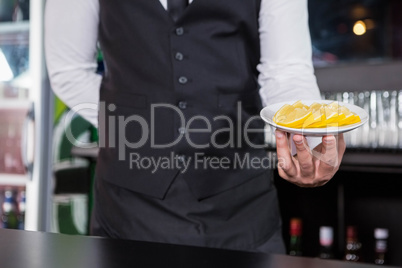 Waiter serving slices of lime