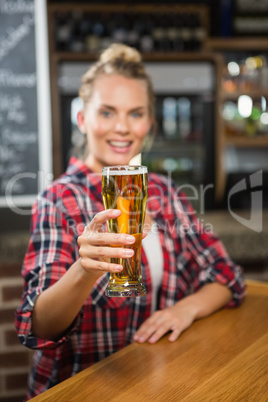 Pretty smiling woman having a beer