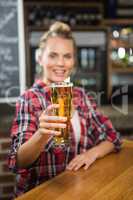 Pretty smiling woman having a beer