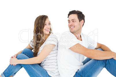 Young couple sitting on floor back to back
