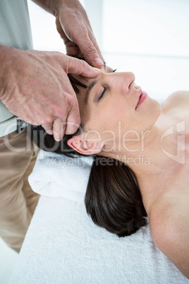 Pregnant woman receiving a massage from masseur