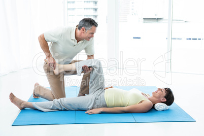 Physiotherapist giving physiotherapy to pregnant woman