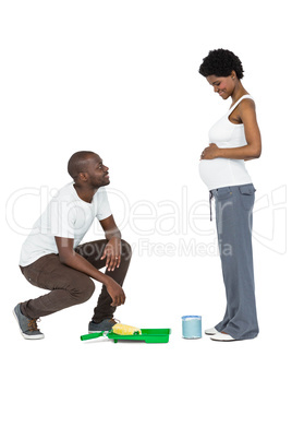 Pregnant couple with paint tin