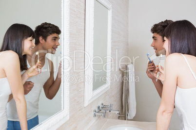 Young couple brushing their teeth