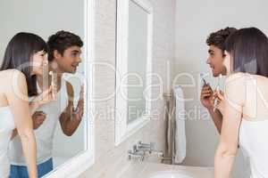 Young couple brushing their teeth