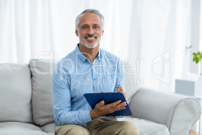 Doctor sitting with a clipboard