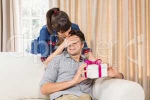 Young man receiving a surprise gift