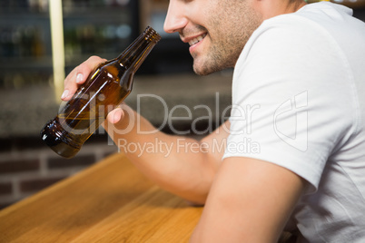 Handsome man holding a bottle of beer