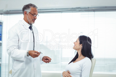 Doctor examining pregnant woman with a stethoscope