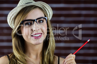 Smiling woman with a pencil