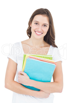 Portrait of cheerful female college student holding books